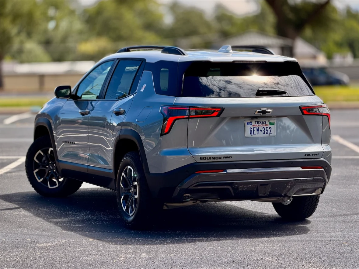 A silver Chevrolet Equinox parked, showcasing its rear side and modern design features.
