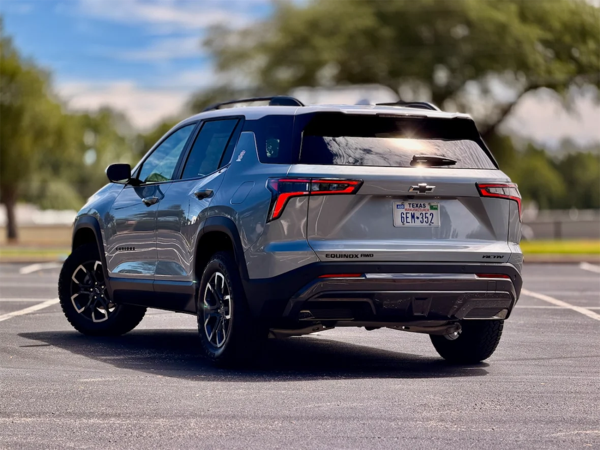 A silver Chevrolet Equinox SUV parked in a lot, showcasing its rear view and sleek design.