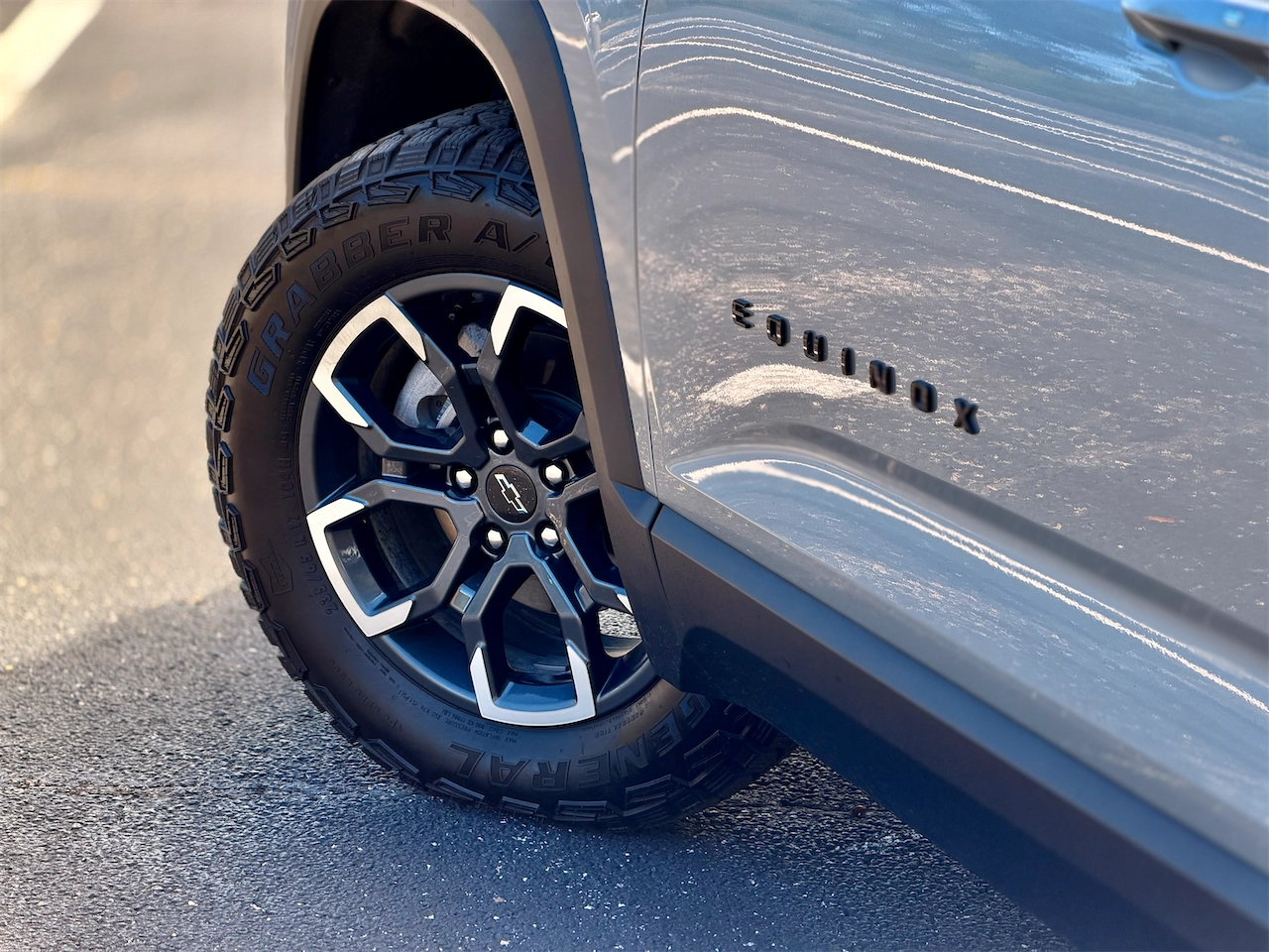 Side profile of the 2026 Equinox ACTIV with blacked-out Equinox door badging