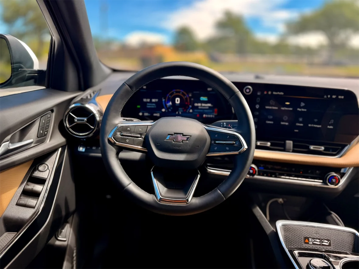 Interior view of a Chevrolet vehicle showing the steering wheel, dashboard, and center console with a digital display.