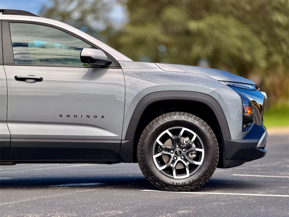 Side view of a silver Chevrolet Equinox SUV parked on asphalt, showcasing its modern design and alloy wheels.