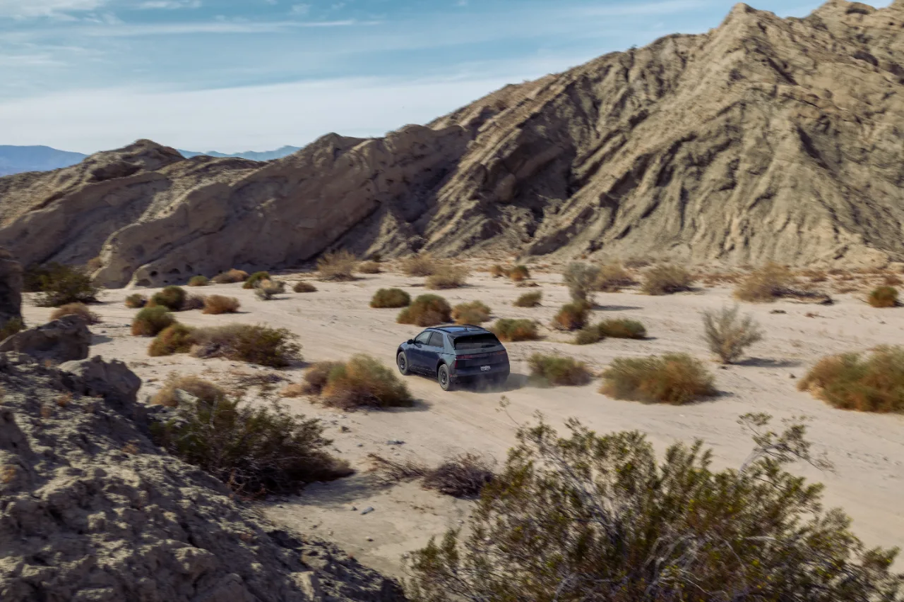IONIQ 5 XRT driving through a desert canyon