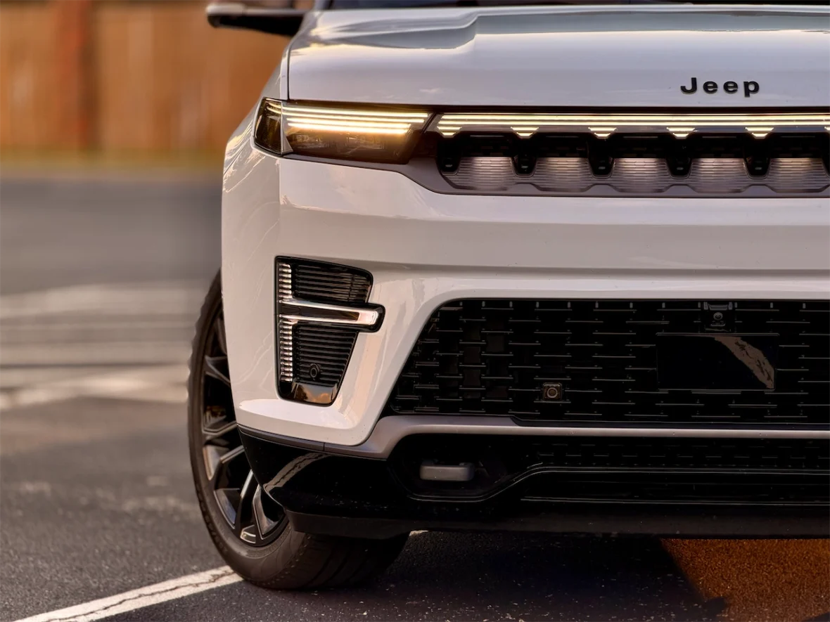 Close-up of the front end of the 2026 Jeep Grand Wagoneer L, showcasing its modern design, grille, and headlights.