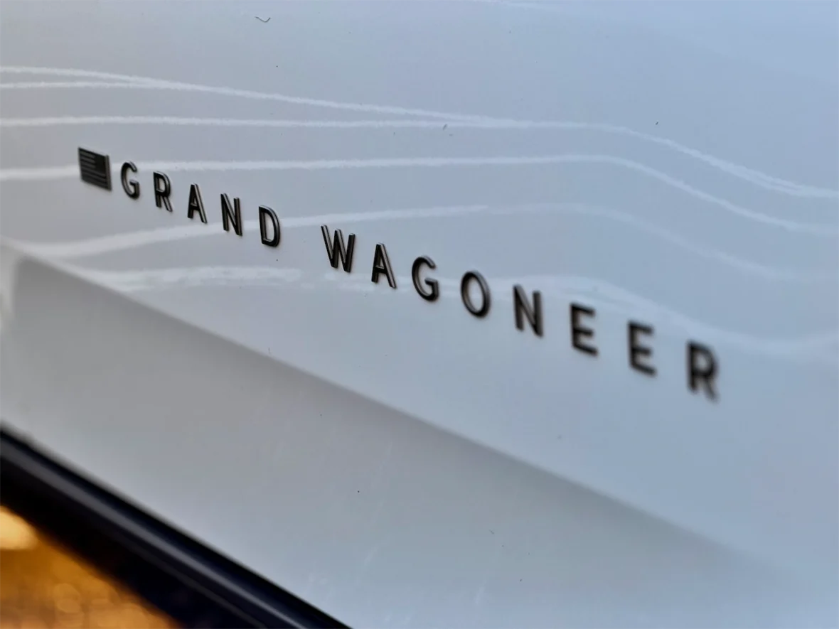 Close-up of the 'Grand Wagoneer' logo on the 2026 Jeep Grand Wagoneer L.