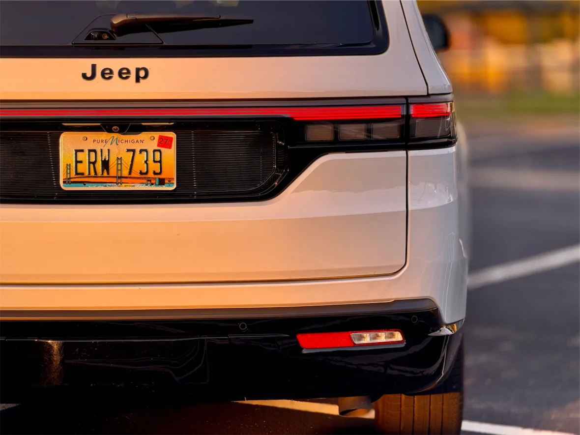 Rear view of the 2026 Jeep Grand Wagoneer L with a visible license plate reading 'ERW 739' and the brand name 'Jeep' on the rear.