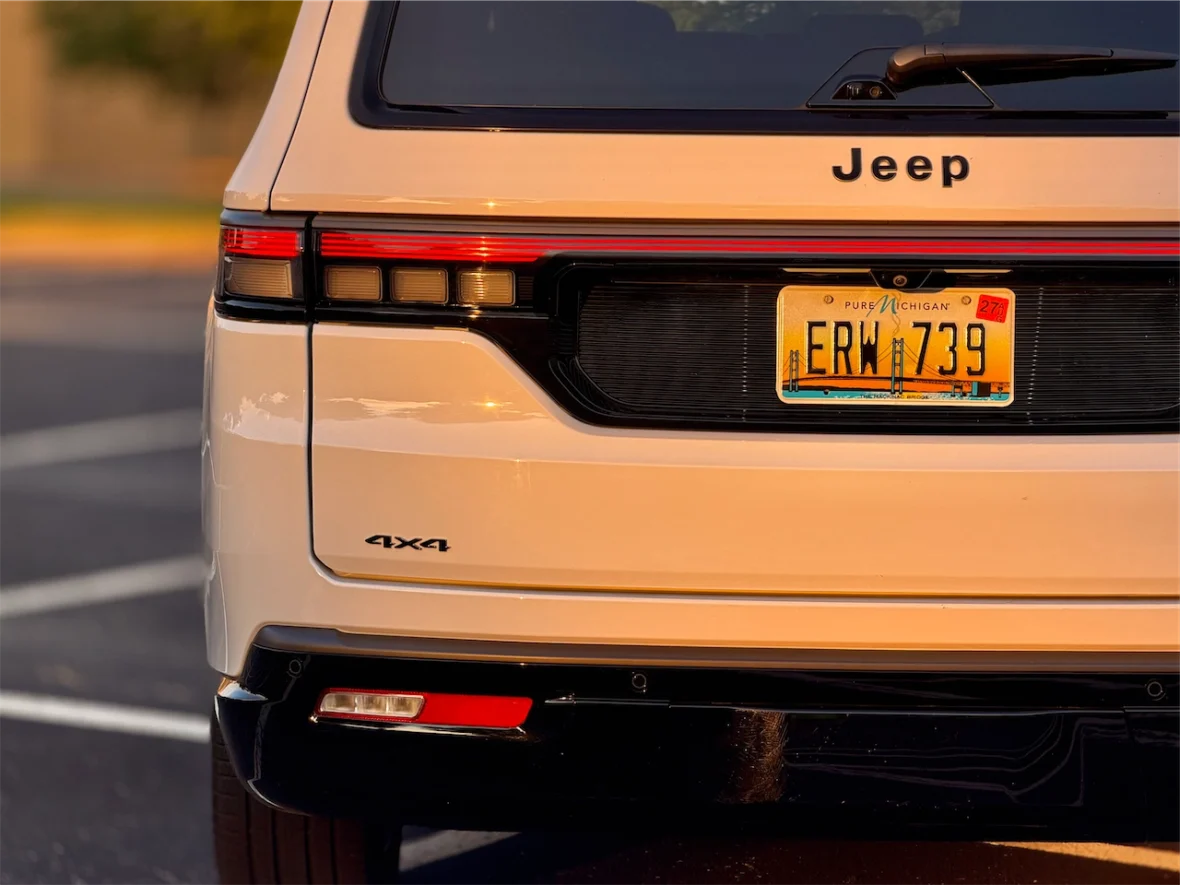 Rear view of the 2026 Jeep Grand Wagoneer L showcasing the brand name, license plate from Michigan, and 4x4 badge.