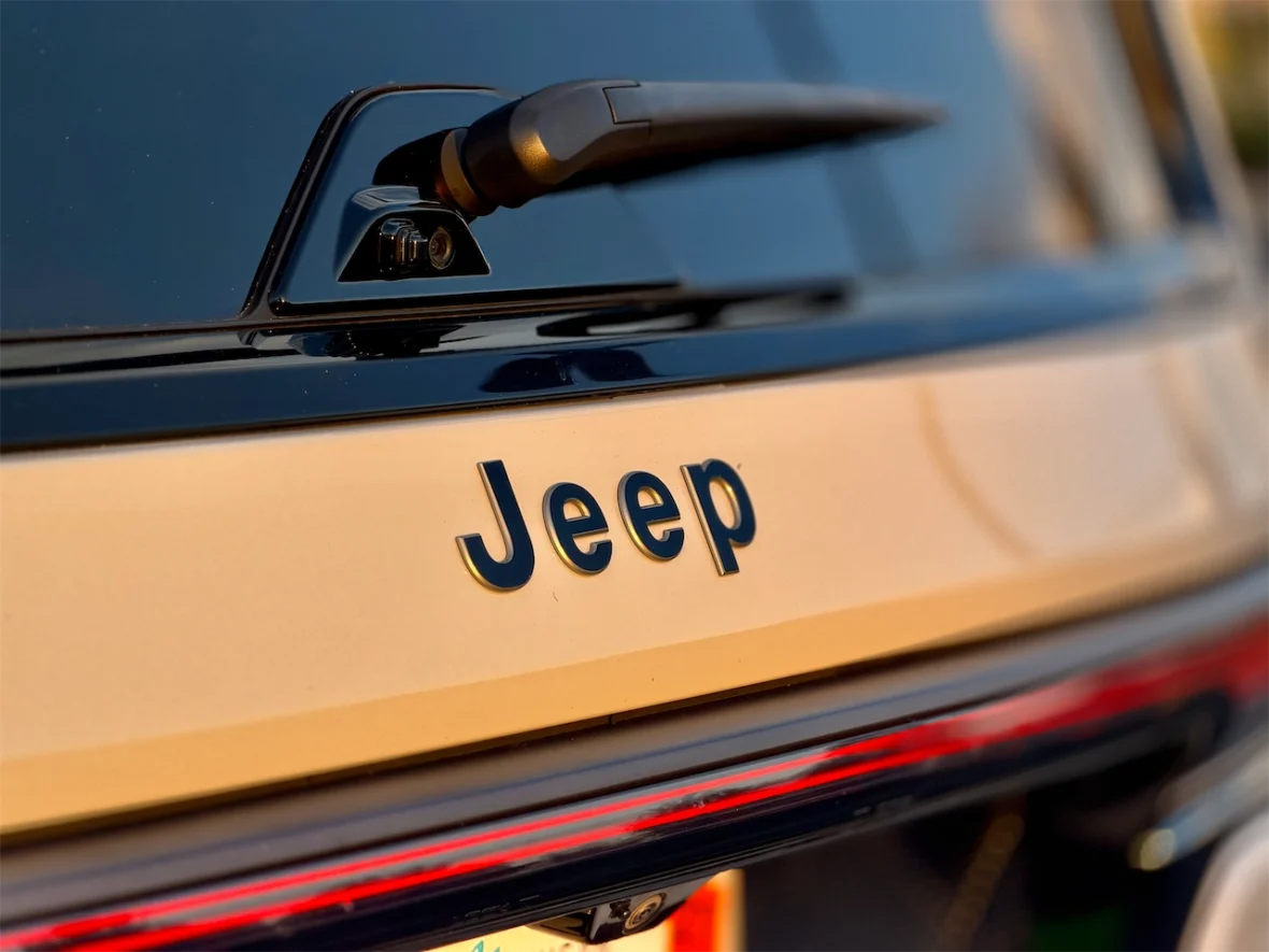 Close-up of the rear of a Jeep vehicle showing the brand name 'Jeep' in bold letters.