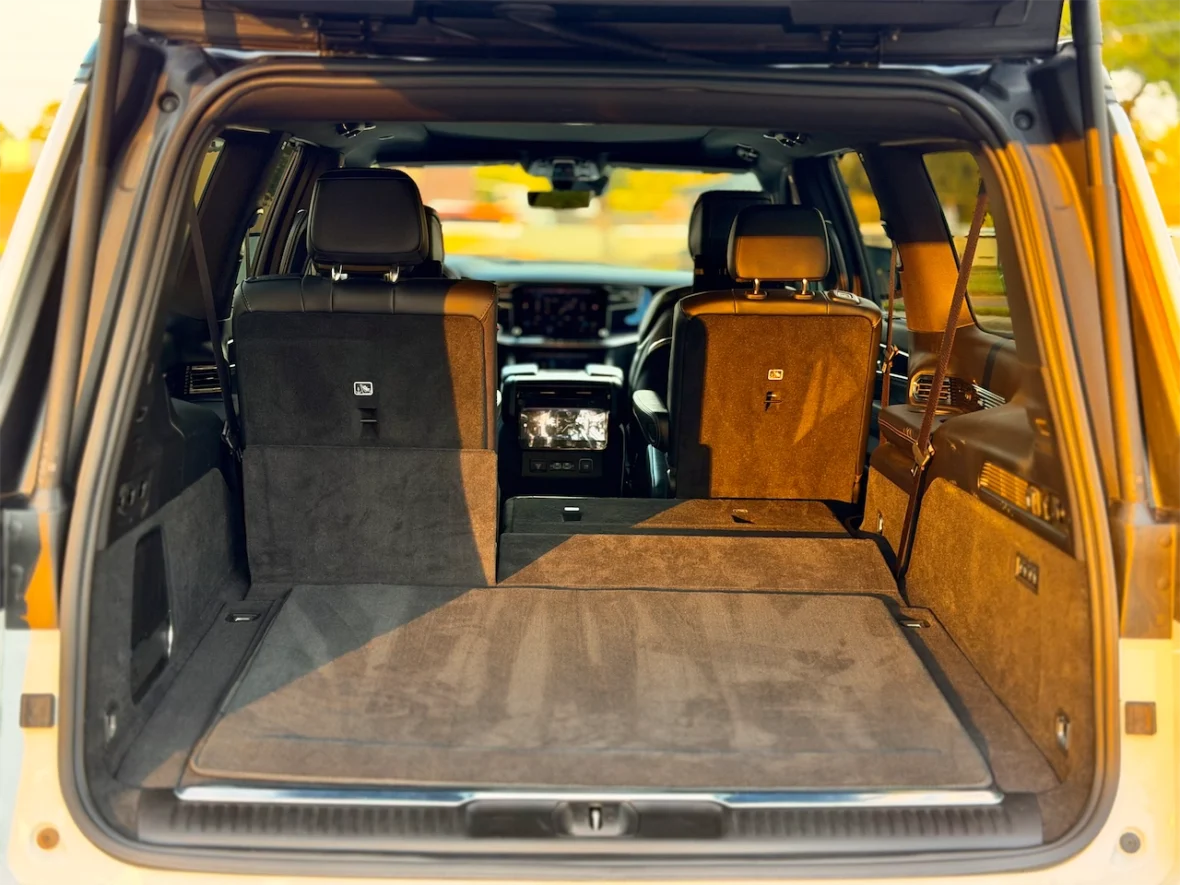 Interior view of an SUV with the rear seats folded down, showing a spacious cargo area.