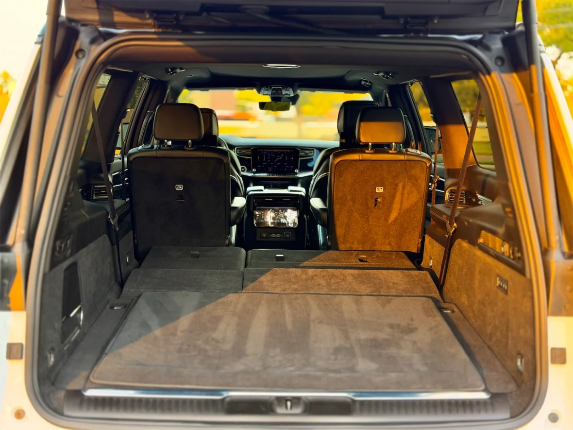 Interior view of a spacious SUV with rear seats folded down, showcasing the cargo area.