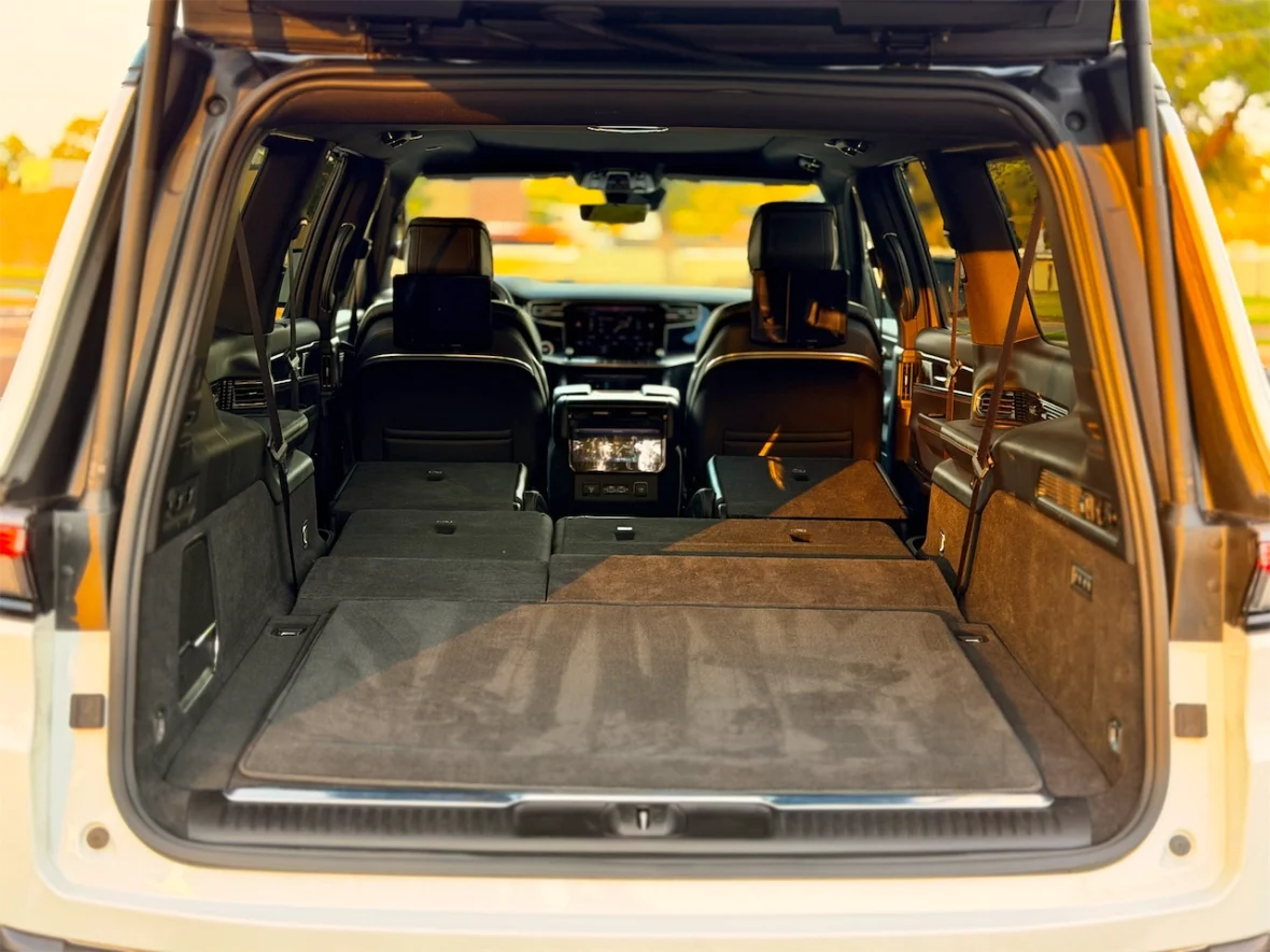 Interior view of an SUV with the rear seats folded down, showing a spacious cargo area.