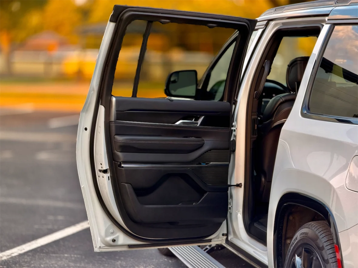 Open door of the 2026 Jeep Grand Wagoneer L showcasing the interior and a black leather seat.