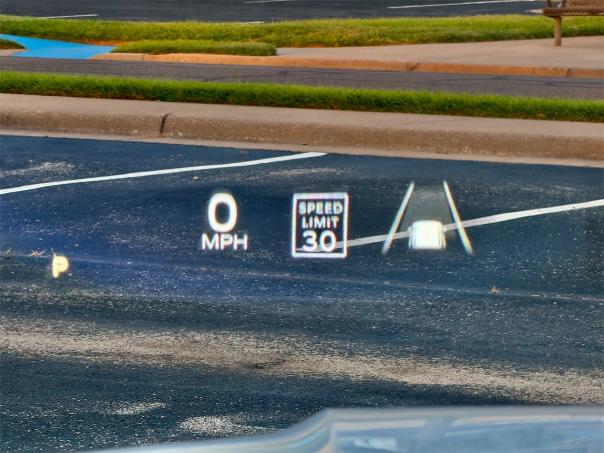 Heads-up display showing speedometer reading of 0 MPH, gear indicator 'P' for park, and a speed limit sign of 30 MPH.