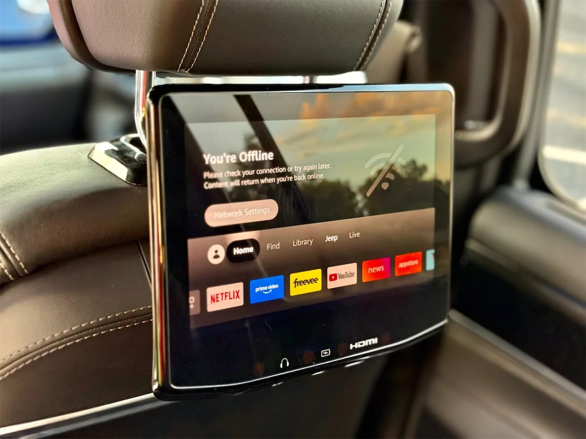 A mounted tablet screen on a car headrest displaying an offline message and network settings options.