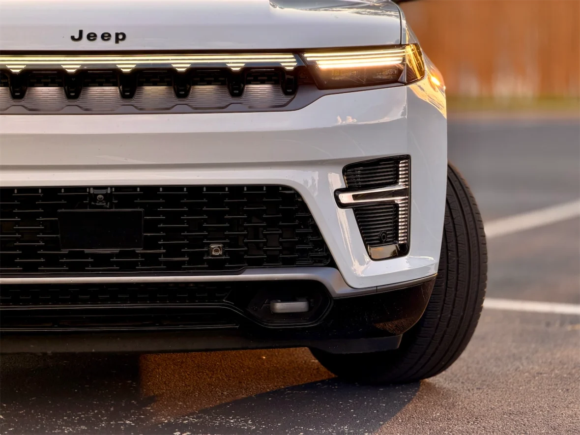 Close-up view of the front grille and bumper of the 2026 Jeep Grand Wagoneer L, showcasing the logo and unique design elements.