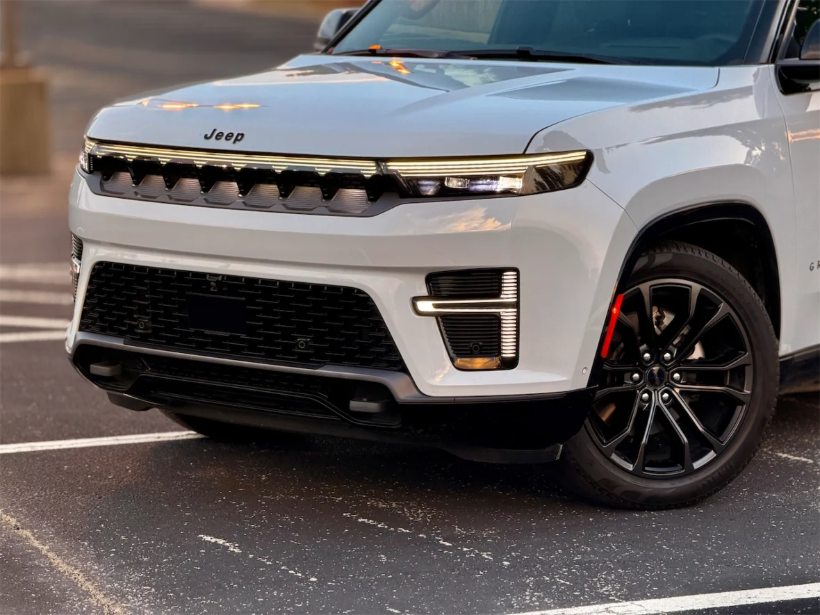 Close-up view of the front of the 2026 Jeep Grand Wagoneer L, showcasing its bold grille and stylish headlights.