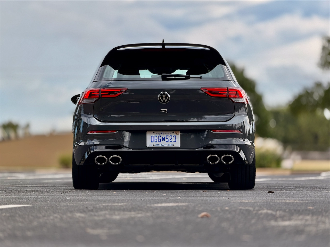 Rear three-quarter with quad exhaust and a rear wing