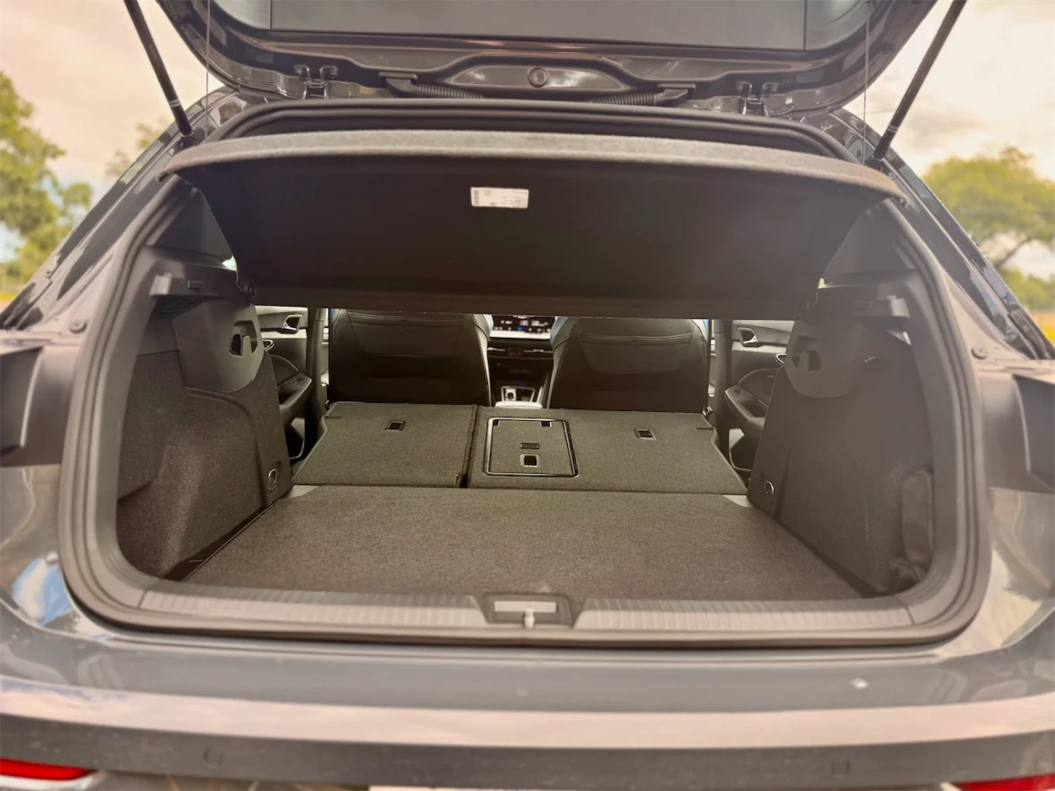 Interior view of a car's trunk with the rear seats folded down, showcasing a spacious storage area.