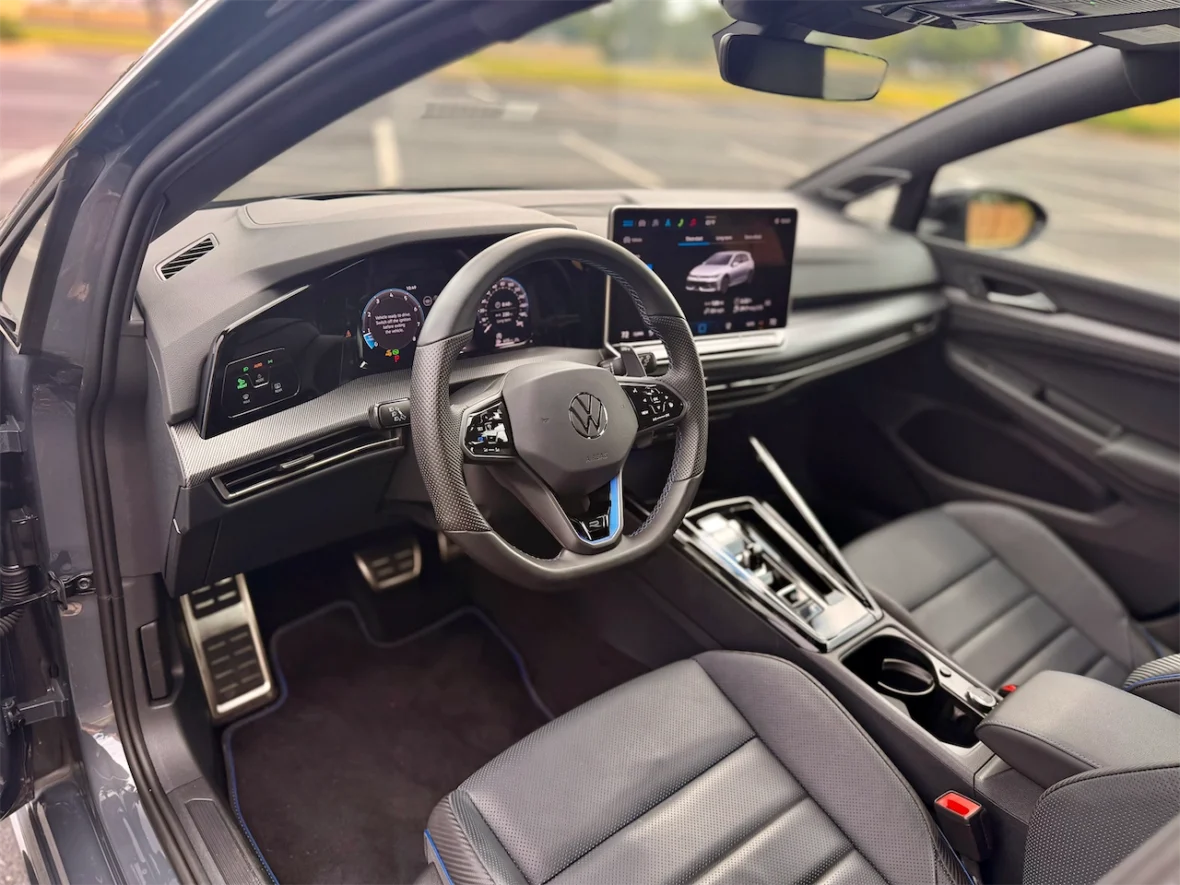 Interior view of a Volkswagen car showcasing the dashboard, steering wheel, touchscreen display, and leather seats.