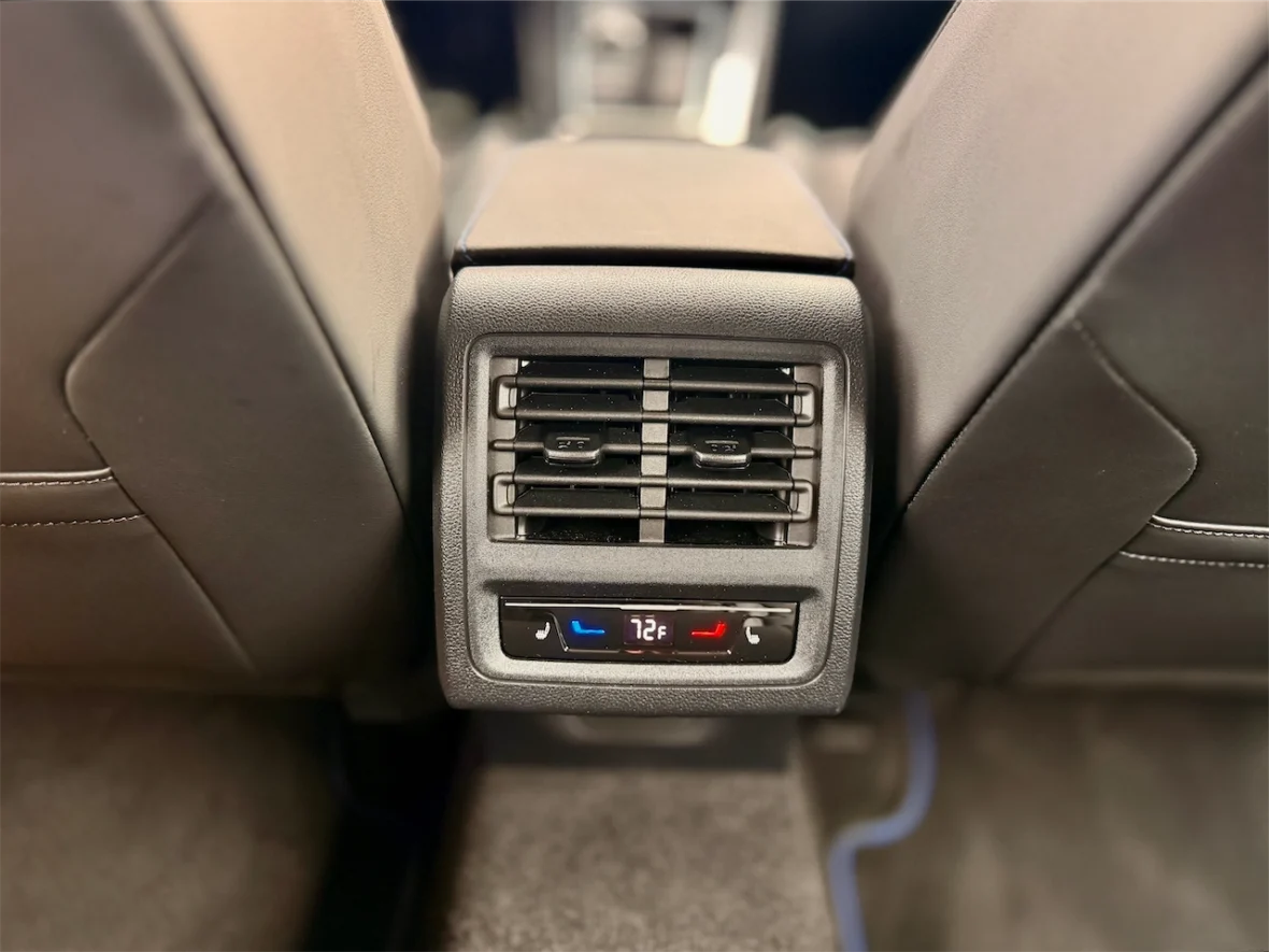 Close-up of a car's rear air conditioning vent with temperature display set to 72°F.