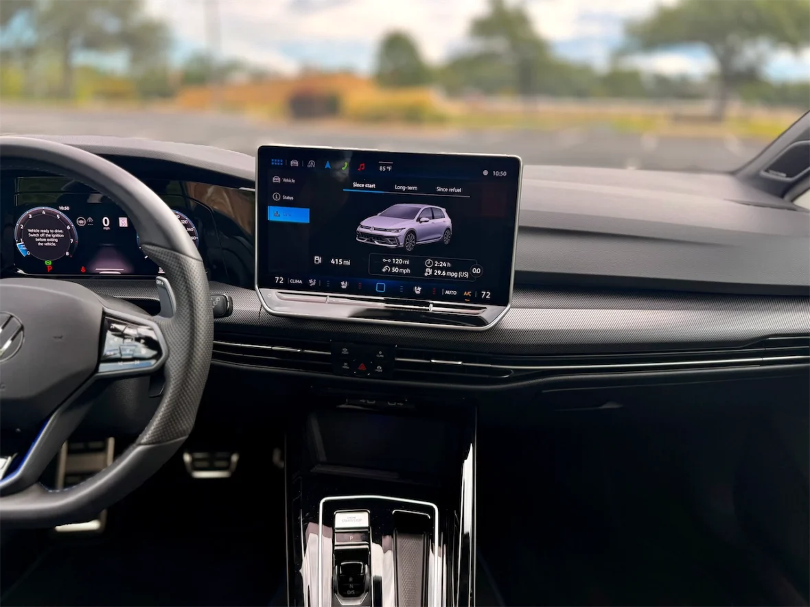 Interior view of a modern car showcasing a digital dashboard display with vehicle status and navigation information.