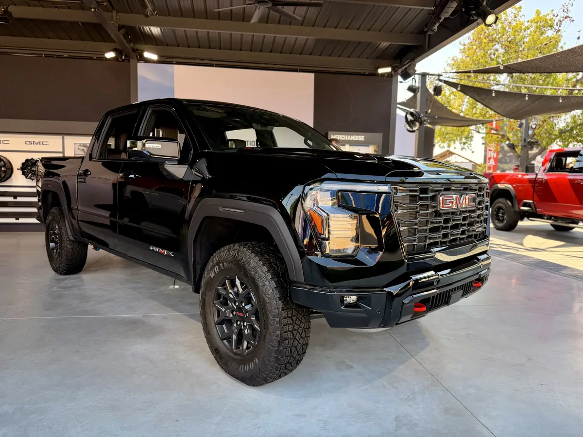 Black Sierra AT4X with red tow hooks and 35-inch tires on display at the GMC booth at the State Fair of Texas