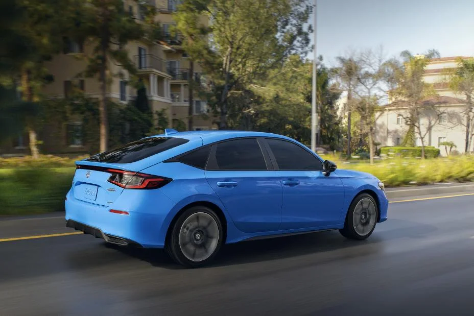 2027 Honda Civic Hatchback Sport Touring Hybrid in blue, rear three-quarter view