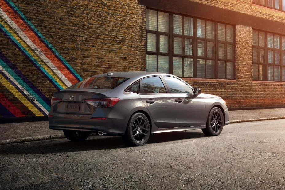 2027 Honda Civic Sport-L sedan rear three-quarter view