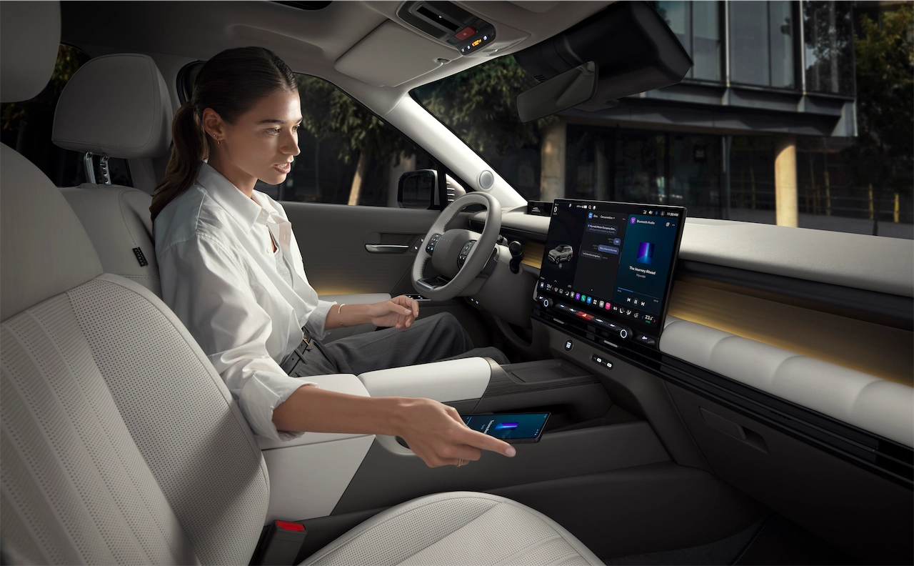 Driver using the Pleos Connect screen in the 2027 Hyundai Tucson
