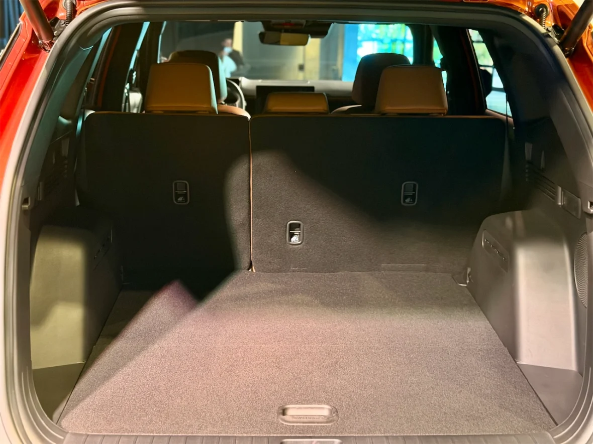 Interior view of the trunk space in a vehicle, showcasing a clean, spacious cargo area with seats folded down.