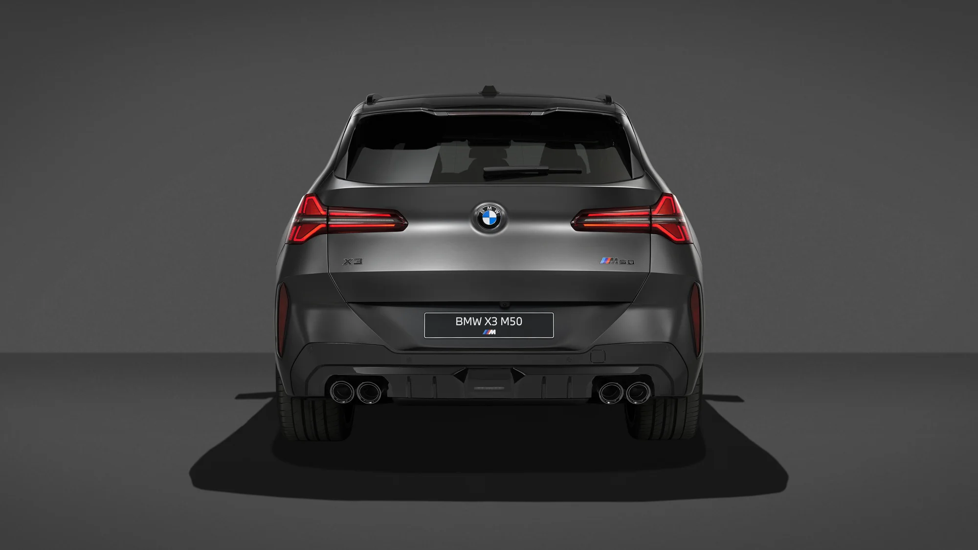 2027 BMW X3 M50 xDrive Black Package rear view with quad exhaust tips