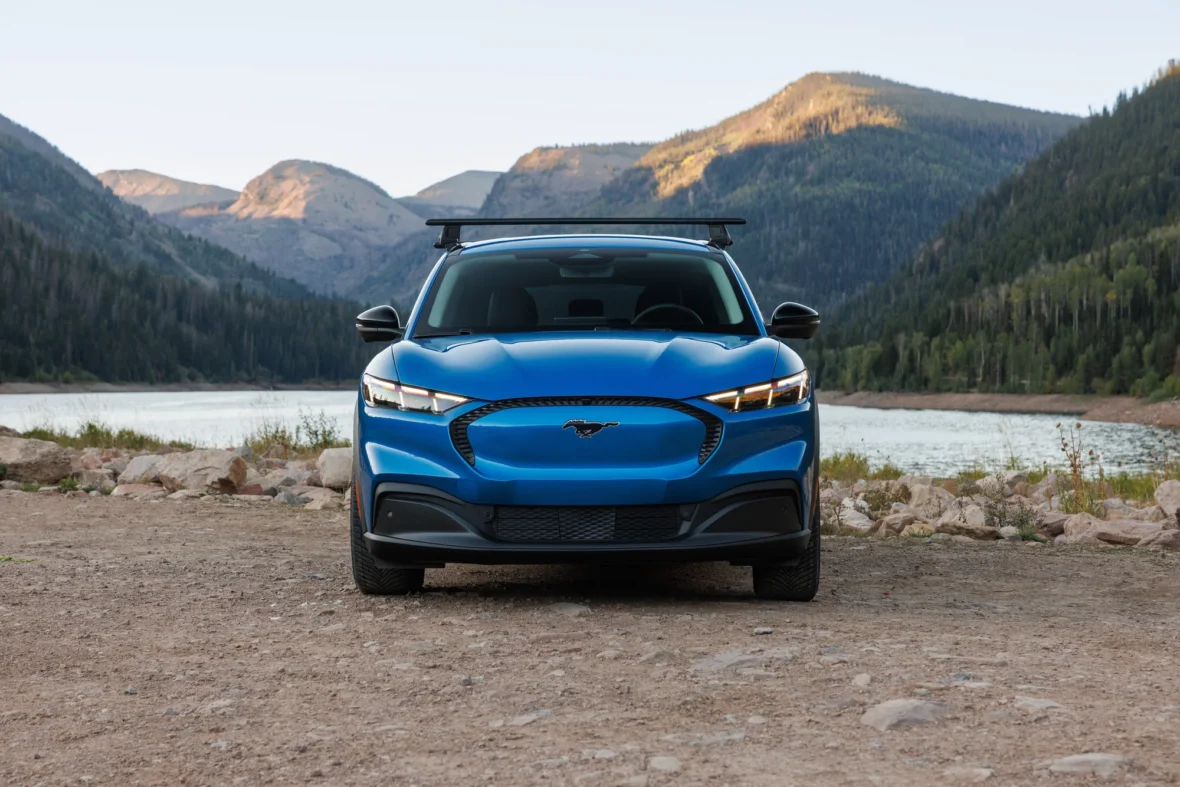 Front view of the 2027 Mustang Mach-E Trail on a gravel lakeshore