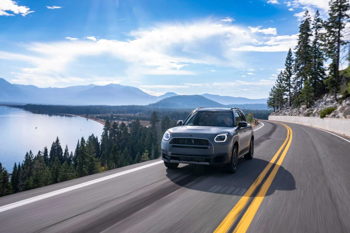 MINI Countryman Untamed Edition driving along a lakeside mountain highway
