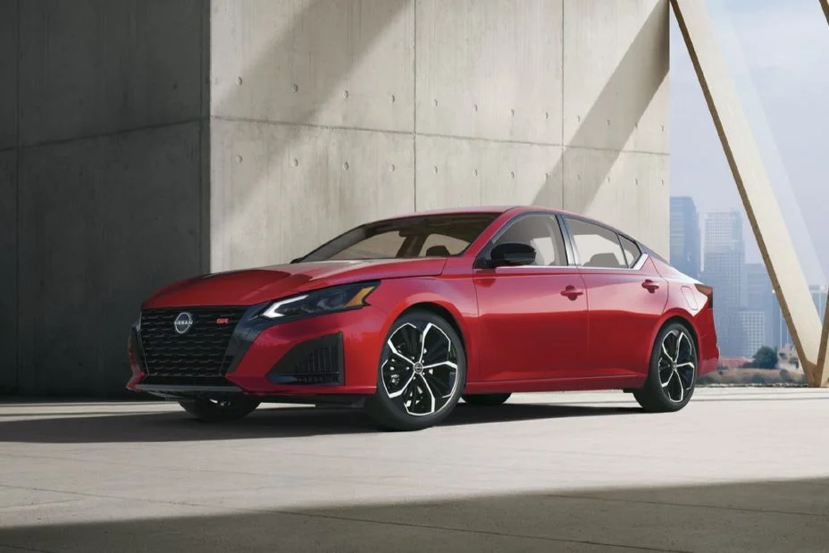 2027 Nissan Altima front three-quarter view parked in front of a concrete wall