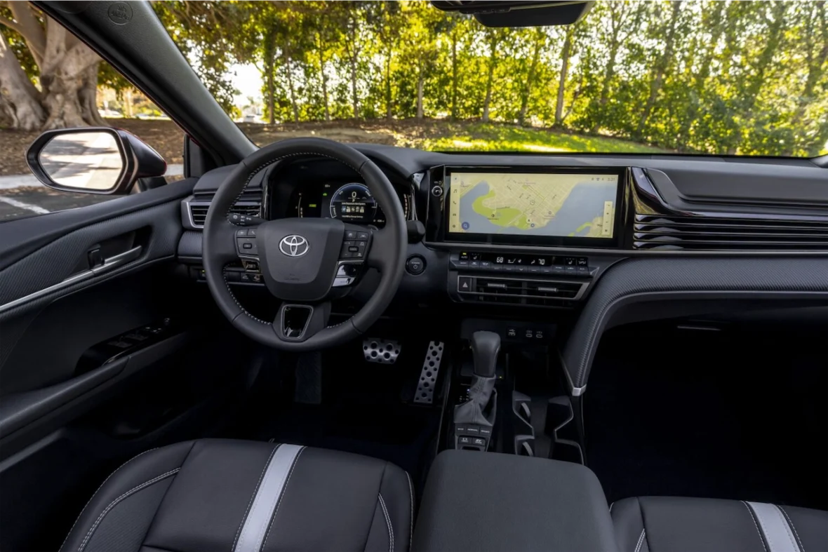 Interior view of a Toyota car showcasing the dashboard, steering wheel, and touchscreen display with a map.