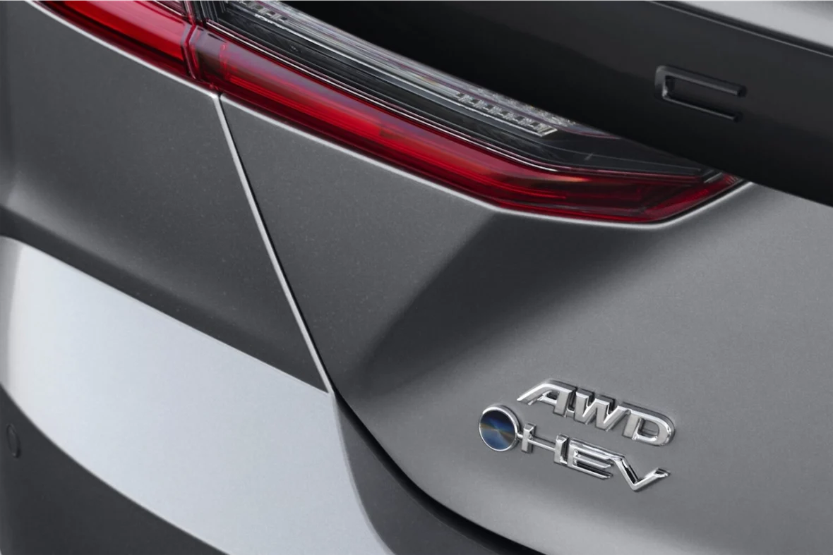 Close-up of a car's rear with an AWD HEV badge and a sleek taillight design.