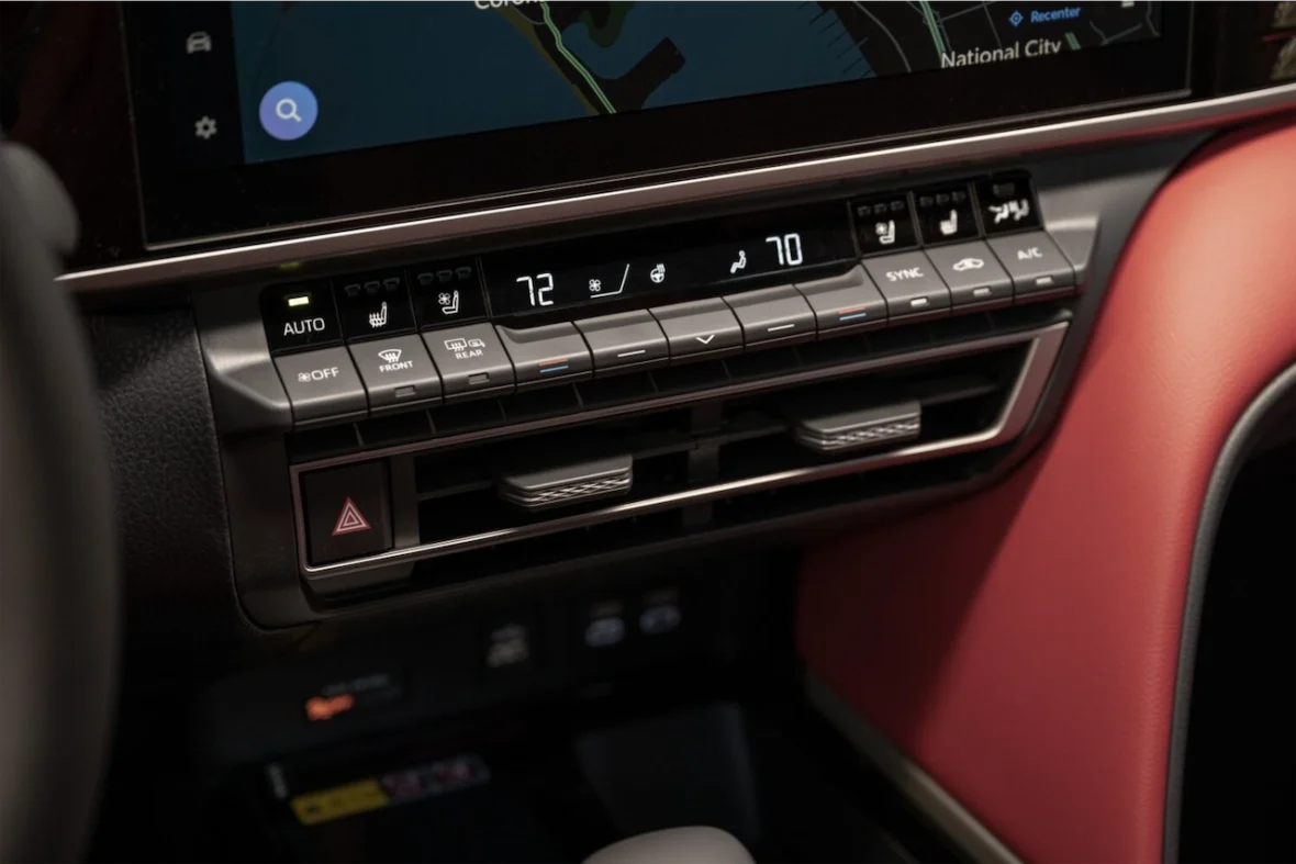 Close-up of a car's climate control panel showing temperature settings and various control buttons.