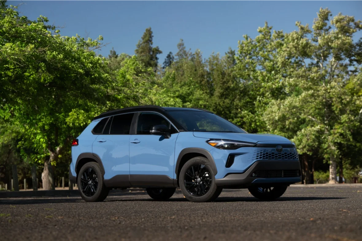 Cavalry Blue Corolla Cross Hybrid XSE in a wooded setting