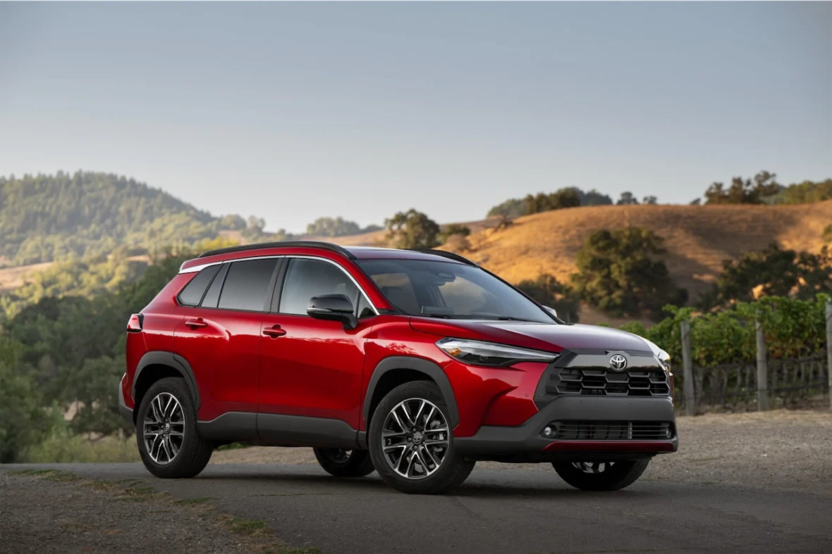 2027 Toyota Corolla Cross XLE in Soul Red Crystal parked on a hillside