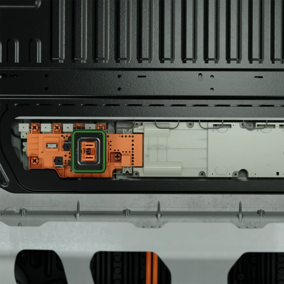 Close-up view of an electronic circuit board featuring an orange component with a green outline, positioned within a black casing.