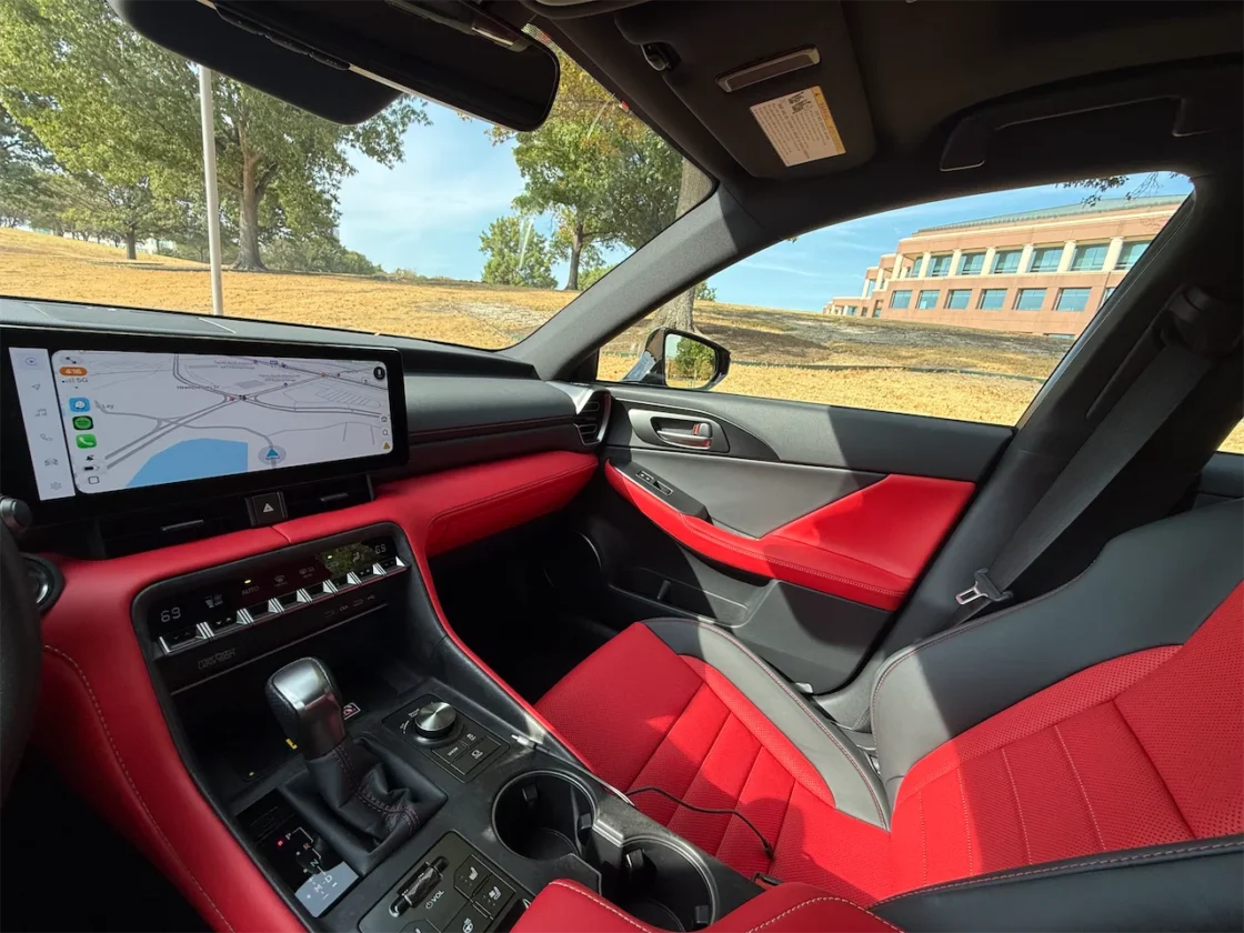 Red and black sport sedan interior with digital gauges