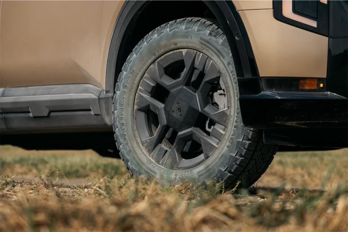 Close-up of a vehicle's wheel showcasing a rugged tire in a natural setting.