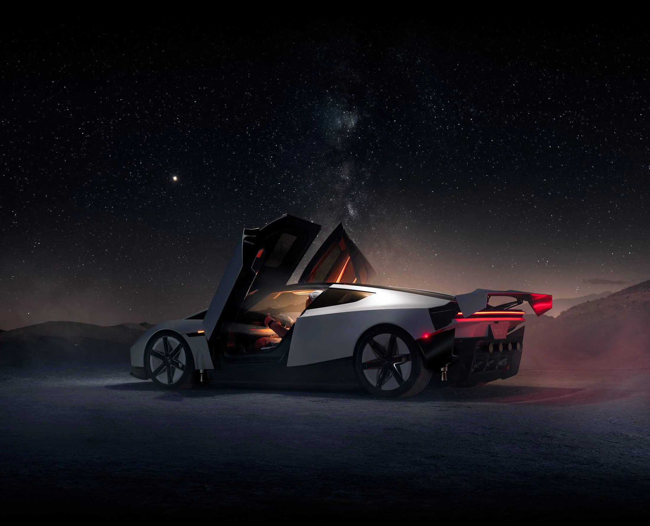 New Tesla Roadster with doors raised at night