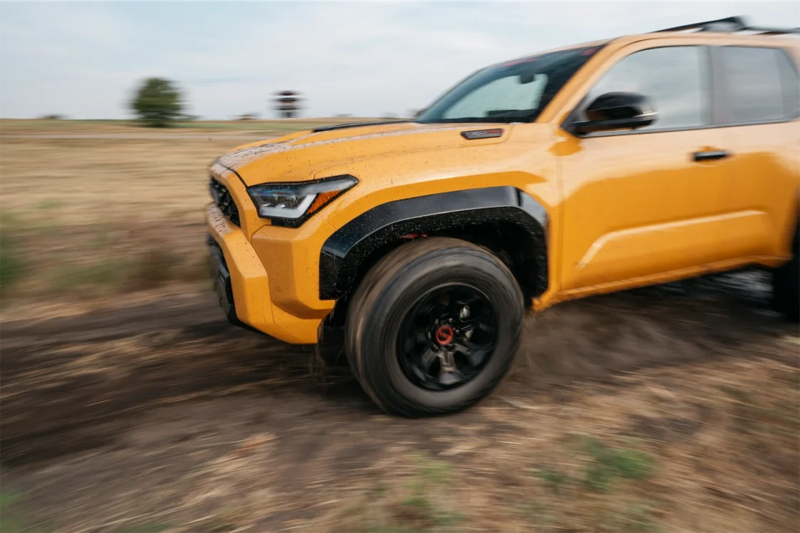Close-up of a Hot Honey Toyota 4Runner TRD Pro driving across a dirt course.