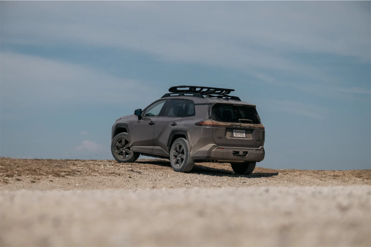 Rear view of the 2026 Toyota RAV4 PHEV Woodland on gravel