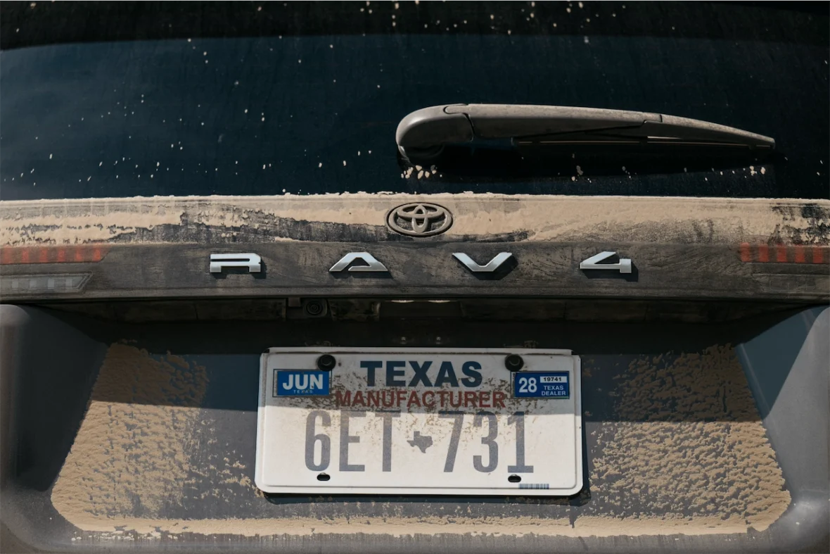 RAV4 lettering on a dusty liftgate