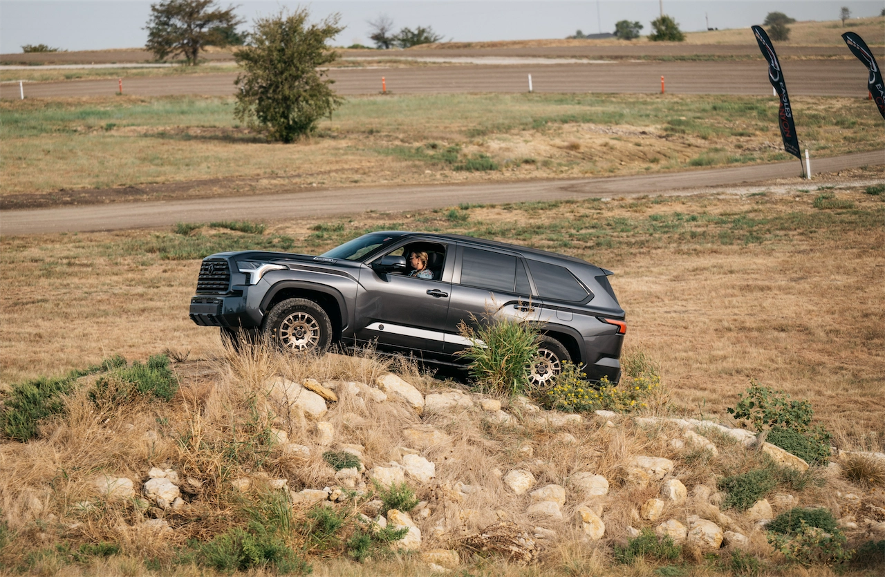 2027 Toyota Sequoia Trailhunter climbing over rocks on an off-road course