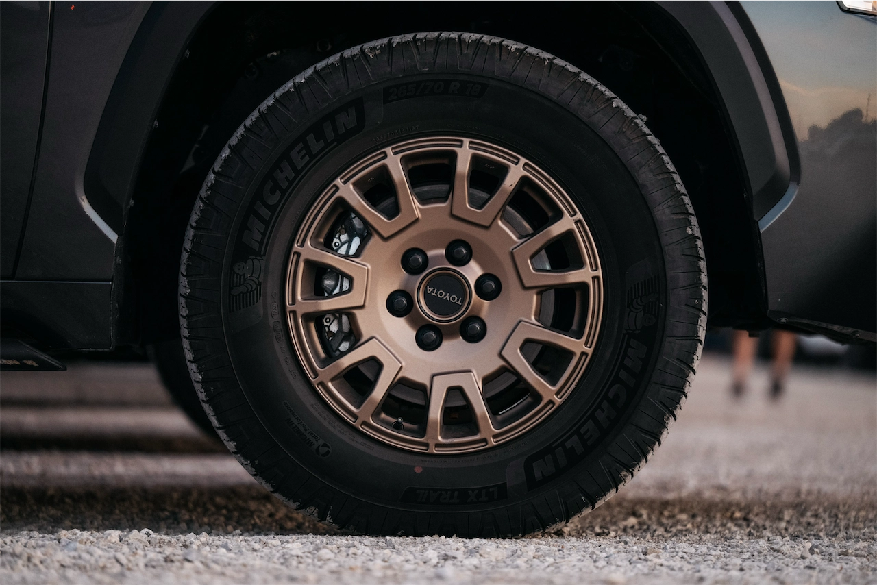 Bronze 18-inch wheel and Michelin LTX Trail tire on a gray SUV