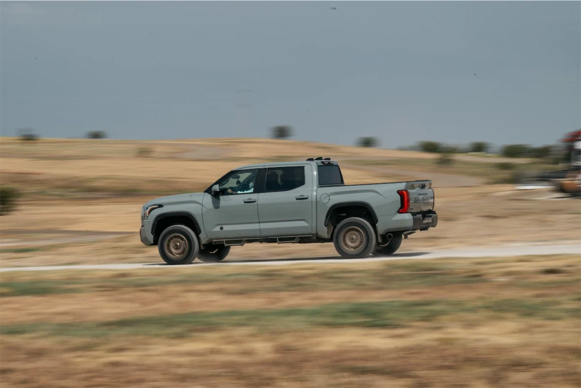 Side view of the 2027 Toyota Tundra Trailhunter driving on a dirt course