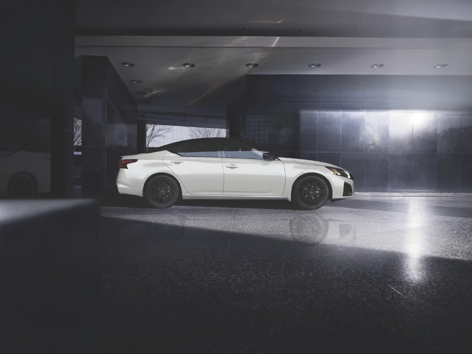 Right side profile of the midsize sedan parked in a black tiled space, shown in 2026 form