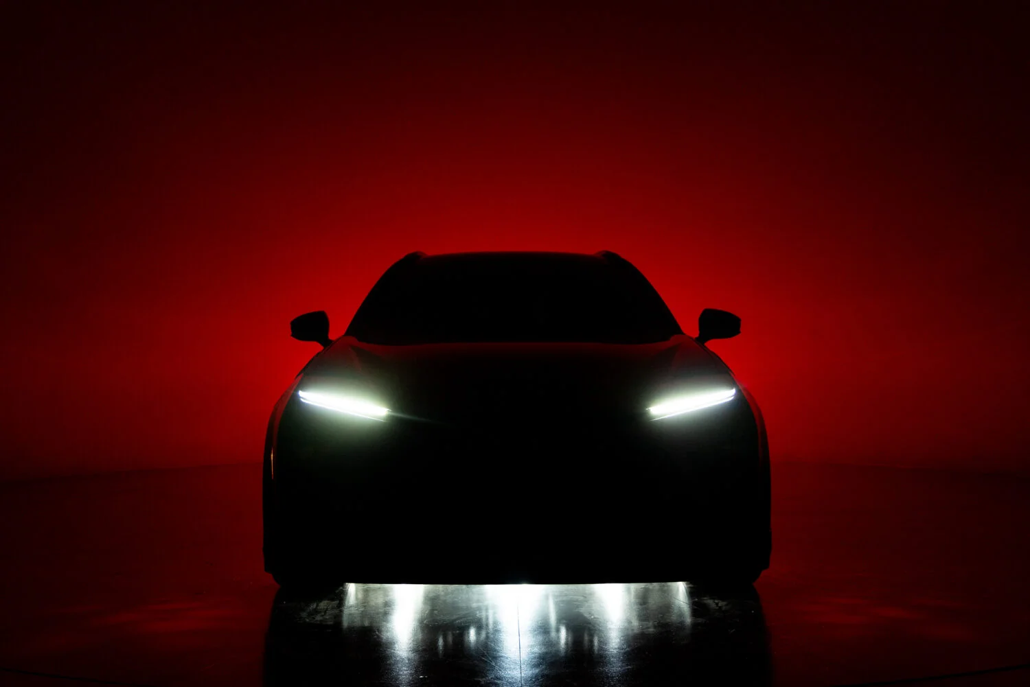 Crown Signia GT-S Concept headlights glowing against a red backdrop